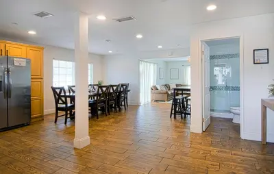 a kitchen and dining room with a table and a refrigerator at F-22 Castle House 2 in Anaheim