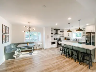 a kitchen with white cabinets and a table and chairs at F-23 Rapunzels Tower in Anaheim