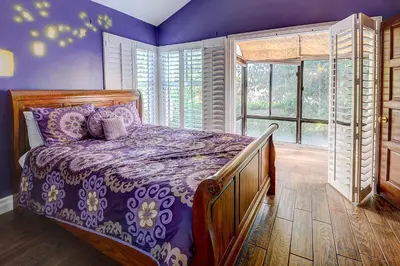 a bedroom with a bed with a purple comforter at F-23 Rapunzels Tower in Anaheim