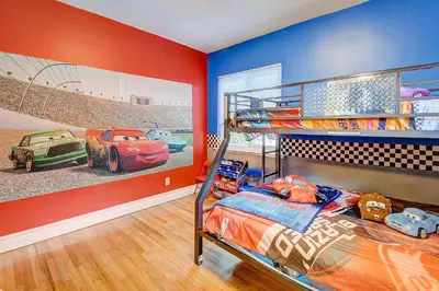 a bedroom with a bunk bed with cars on the wall at F-23 Rapunzels Tower in Anaheim