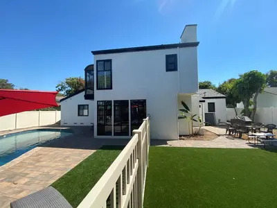 a white house with a fence and a swimming pool at F-23 Rapunzels Tower in Anaheim