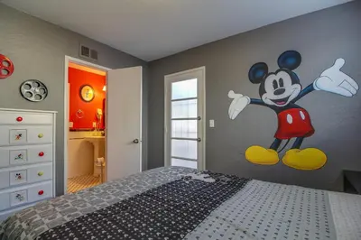 a bedroom with a mickey mural on the wall at F-24 Mickeys House in Anaheim
