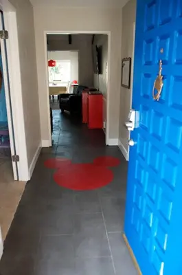 a hallway with a red rug on the floor at F-24 Mickeys House in Anaheim