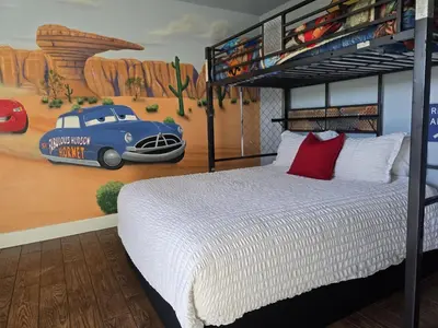 a bedroom with a bed and a mural of a car at F-34 Minnies House in Anaheim