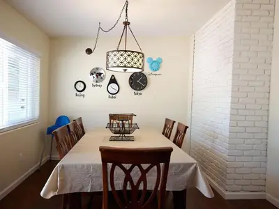 a dining room with a table with chairs and a chandelier at F-30 Small World in Anaheim