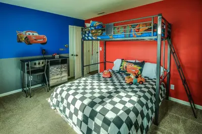 a bedroom with a bunk bed with toy cars on it at F-30 Small World in Anaheim