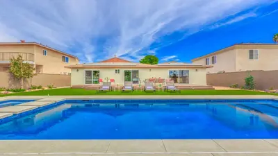 a swimming pool in front of a house at F-27 Carnelian in Anaheim