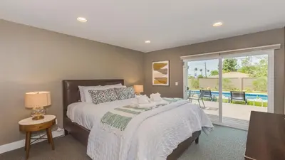 a bedroom with a bed and a sliding glass door at F-27 Carnelian in Anaheim