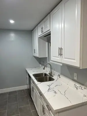 a kitchen with white cabinets and a sink at Beautiful 2-bedroom downstairs unit by LAX, SoFi, BMO, USC in Los Angeles