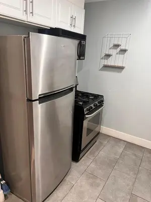 a kitchen with a stainless steel refrigerator and a stove at Beautiful 2-bedroom downstairs unit by LAX, SoFi, BMO, USC in Los Angeles