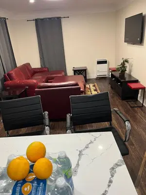 a living room with a couch and oranges on a table at Beautiful 2-bedroom downstairs unit by LAX, SoFi, BMO, USC in Los Angeles