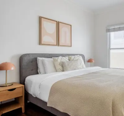 a white bedroom with a large bed with pillows at Prime Santa Monica 1 bed & bath in Los Angeles