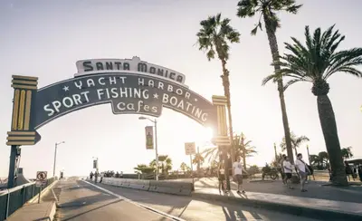 a sign for the beach with palm trees and people walking at Prime Santa Monica 1 bed & bath in Los Angeles