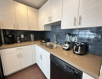 a kitchen with white cabinets and a sink at Prime Santa Monica 1 bed & bath in Los Angeles