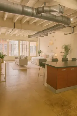 a large living room with a bed and a couch at Loft in Downtown Los Angeles in Los Angeles