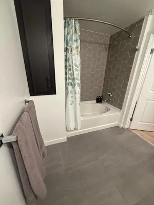 a bathroom with a bath tub and a shower at Vine Loft FREE DESIGNATED PARKING & WIFI close to Universal Studios in Los Angeles
