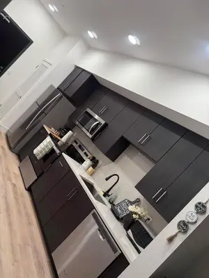 an overhead view of a kitchen with black cabinets at Vine Loft FREE DESIGNATED PARKING & WIFI close to Universal Studios in Los Angeles