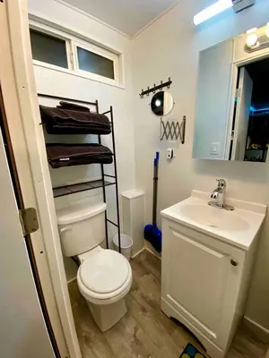 a small bathroom with a toilet and a sink at Cozy Container in Devore Heights, California, for Glamping Getaways on Route 66 in Devore Heights