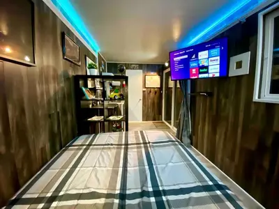 a room with a tv and a tiled floor at Cozy Container in Devore Heights, California, for Glamping Getaways on Route 66 in Devore Heights