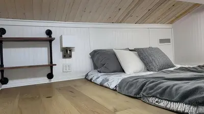 a bedroom with a bed and a wooden ceiling at Tiny House Living with In Unit Laundry Steps from Kaiser in Litton Industries Heliport