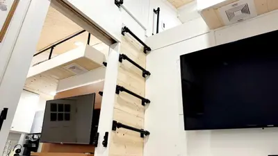 a large flat screen tv on the wall of a room at Tiny House Living with In Unit Laundry Steps from Kaiser in Litton Industries Heliport