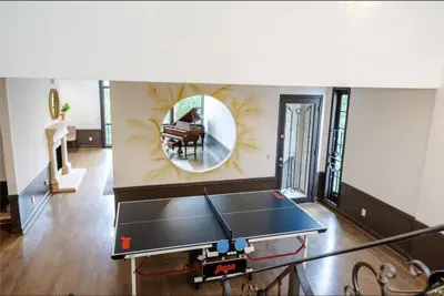 a ping pong table in a living room with a mirror at 6BR-Music Studio-Pool-Spa & Games in Sherman Oaks