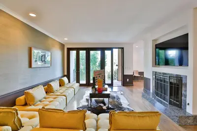 a large living room with couches and a fireplace at 6BR-Music Studio-Pool-Spa & Games in Sherman Oaks