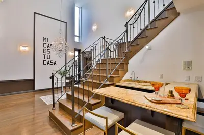 a staircase in a room with a table and chairs at 6BR-Music Studio-Pool-Spa & Games in Sherman Oaks