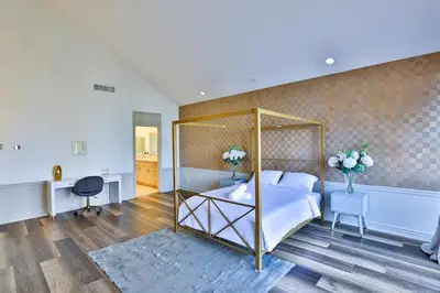 a bedroom with a canopy bed and a desk at 6BR-Music Studio-Pool-Spa & Games in Sherman Oaks