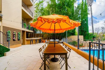 a wooden table with an umbrella on a patio at 6BR-Music Studio-Pool-Spa & Games in Sherman Oaks