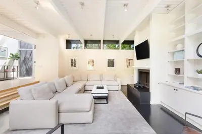 a living room with a white couch and a tv at Malibu Reserve by Stay Awhile Villas in Malibu