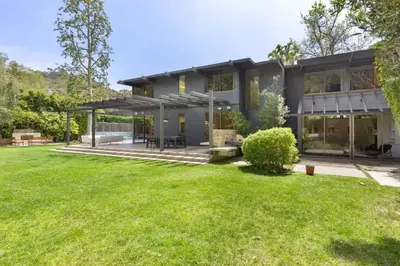 a house with a lawn in front of it at Malibu Reserve by Stay Awhile Villas in Malibu