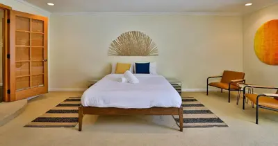 a bedroom with a large white bed and a desk at City Paradise Saltwater Pool-Spa and Ping-Pong in Los Angeles