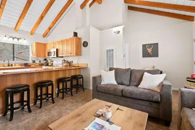 a living room with a couch and a table at Bluebird Cabin, Indoor Fireplace, Next to Lake! in Green Valley Lake