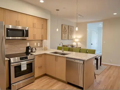 a kitchen with a sink and a stove top oven at Boutique KTown Stays With Breathtaking Rooftop Views in Los Angeles