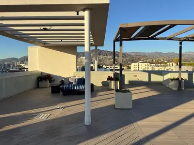 a rooftop deck with a view of a city at Elegant & Charming 2BR Apartment in Glendale