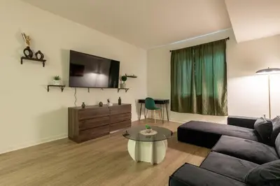 a living room with a couch and a flat screen tv at Elegant & Charming 2BR Apartment in Glendale