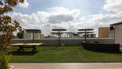 a patio with a picnic table and grass at Lovely and Modern Apartment in Glendale