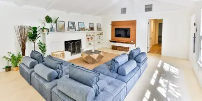 a living room with two blue couches and a fireplace at Pool & Spa Ping-Pong Mini-Golf & 5BR in Sherman Oaks