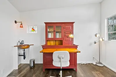 a desk with a white chair in a room at The Robinson Tree House in Silver Lake in Los Angeles