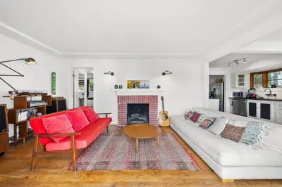 a living room with a red couch and a fireplace at The Robinson Tree House in Silver Lake in Los Angeles
