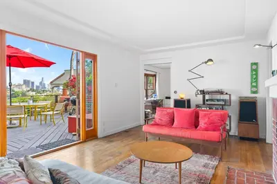 a living room with a red couch and a table at The Robinson Tree House in Silver Lake in Los Angeles