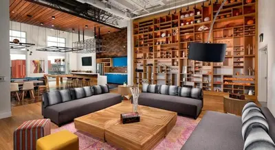 a living room with two couches and a table at Colorful penthouse near DTLA in Los Angeles