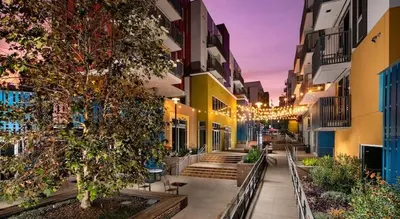 a city street with some buildings and a tree at Colorful penthouse near DTLA in Los Angeles