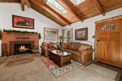 a living room with a couch and a fireplace at Comstock Cabin by Rather Be Properties in Big Bear Lake