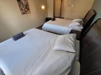 two beds in a hotel room with white sheets at Great Location Double Queen Bed Unit in Los Angeles