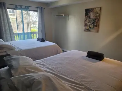 a room with two beds and a window at Great Location Double Queen Bed Unit in Los Angeles
