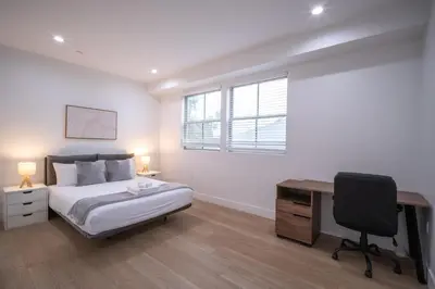 a bedroom with a bed and a desk and a computer at Stylish Private Room by Downtown LA with Private Parking in Los Angeles