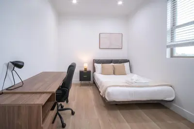 a bedroom with a desk and a bed and a desk and chair at Stylish Private Room by Downtown LA with Private Parking in Los Angeles