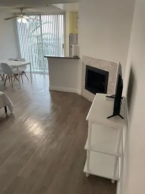 a living room with a fireplace and a computer on a desk at Hollywood Spectacular Loft FREE Designated parking in Los Angeles